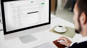 a man composing an email on computer