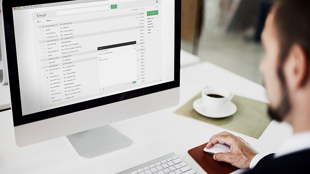a man composing an email on computer