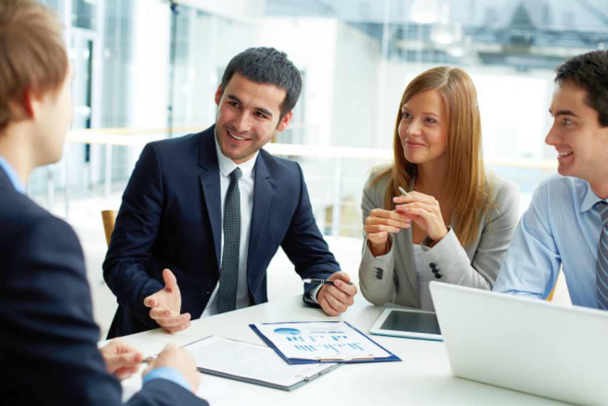 colleagues discussing analytics | How to Improve the Sales with Reporting & Analytics