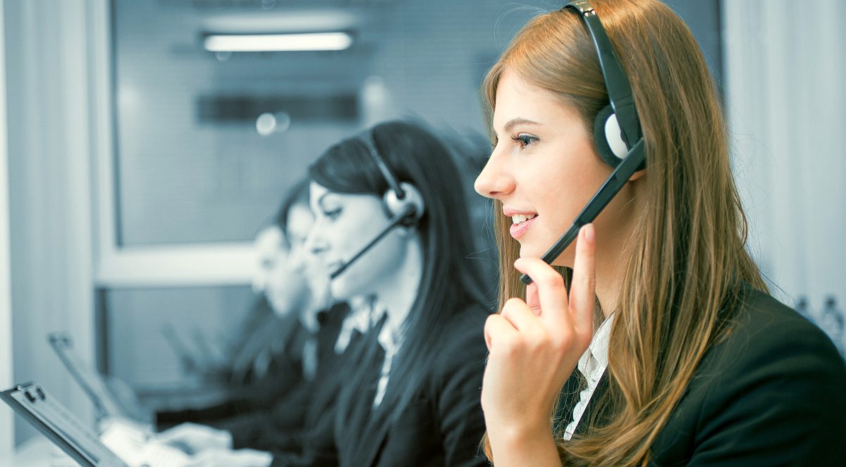 woman answering customer phone queries | How To Transform Customer Service Into A Sales Machine | customer care services